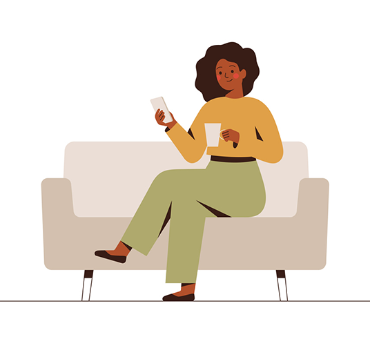 The businesswoman is sitting on the couch with a mobile phone at the break time.